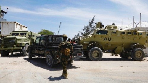FILE PHOTO: African Union peacekeepers stand next to armoured personnel carriers (APC) as they ... FILE PHOTO: African Union peacekeepers stand next to armoured personnel carriers (APC) as they ...