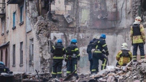 Rescues work at a site of a residential building heavily damaged by a Russian missile strike, amid ...