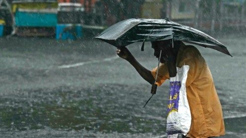 A pedestrian wades through a flooded street after heavy rains in Chennai on December 4, 2023. ... A pedestrian wades through a flooded street after heavy rains in Chennai on December 4, 2023. ...