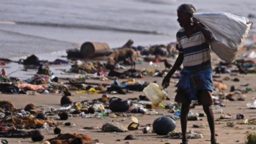 epa11005470 A person searches for recyclable material amidst the garbage washed ashore on ...