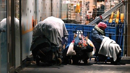 A homeless woman sits next to carriages with her goods in the pedestrian zone in Dortmund, western ... A homeless woman sits next to carriages with her goods in the pedestrian zone in Dortmund, western ...