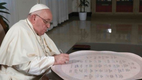 A handout picture provided by the Vatican Media shows Pope Francis signing the 'Confluence of ... A handout picture provided by the Vatican Media shows Pope Francis signing the 'Confluence of ...