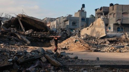 TOPSHOT - A boy walks among the rubble of buildings destroyed in Israeli strikes in Rafah in the ...