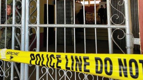 Military personnel stand guard at the entrance of a gymnasium while police investigators look for ... Military personnel stand guard at the entrance of a gymnasium while police investigators look for ...