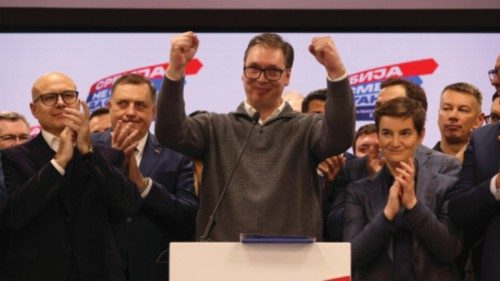 epa11035204 Serbian President Aleksandar Vucic (C) addresses the media at the SNS election night ...