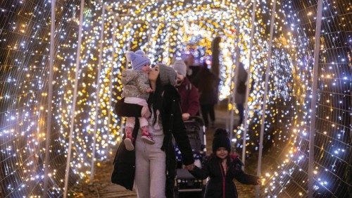 A woman kisses a child on an estate owned by the Salaj family which is lit with 5 million Christmas ... A woman kisses a child on an estate owned by the Salaj family which is lit with 5 million Christmas ...