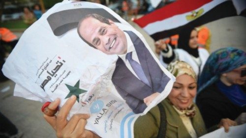 epa11036219 A woman holds a photo of Egyptian President Abdel Fattah al-Sisi as people celebrate the ... epa11036219 A woman holds a photo of Egyptian President Abdel Fattah al-Sisi as people celebrate the ...