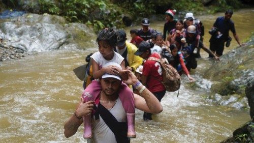 FILE PHOTO: A migrant carries a child as they along with others continue their journey to the U.S. ... FILE PHOTO: A migrant carries a child as they along with others continue their journey to the U.S. ...