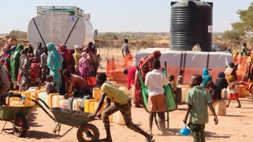 Refugees fleeing the conflict in Sudan queue with their jerrycans to queue to collect drinking water ...