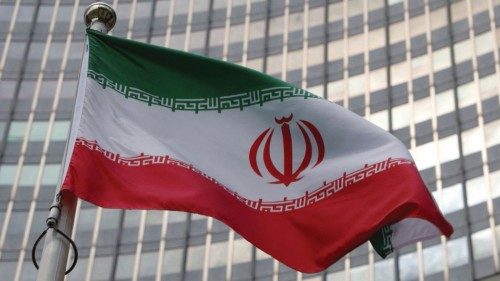 FILE PHOTO: The Iranian flag flutters in front of the International Atomic Energy Agency (IAEA) ...