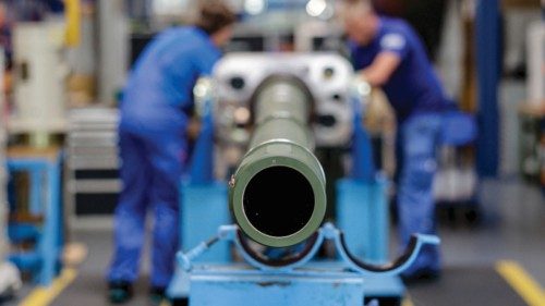 Technicians of German armaments company and automotive supplier Rheinmetall work on a 120mm cannon ...