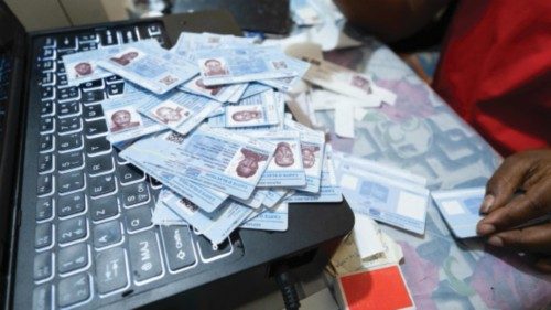 epa11037437 A staff at a branch of the National Independent Election Commission, (CENI) produces ... epa11037437 A staff at a branch of the National Independent Election Commission, (CENI) produces ...
