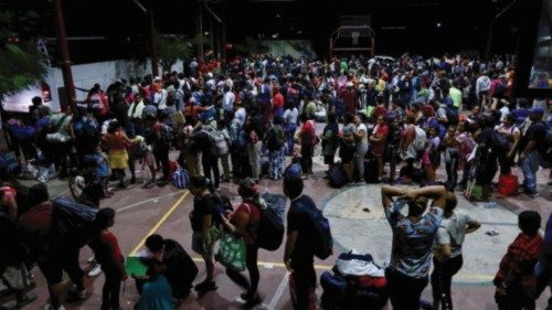 Migrants queue to board buses bound to Huixtla, to continue their procedures and obtain a migration ...