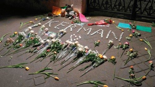 Candles reading 'Kerman' and flowers are displayed during a gathering in tribute to victims in front ... Candles reading 'Kerman' and flowers are displayed during a gathering in tribute to victims in front ...