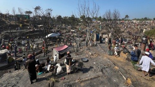 Rohingya refugees work on rebuilding their makeshift shelters after a fire broke out in a camp in ...
