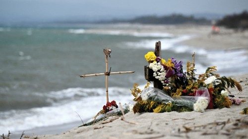 This photograph taken on March 9, 2023, shows flowers and crosses set as a memorial on a beach near ...