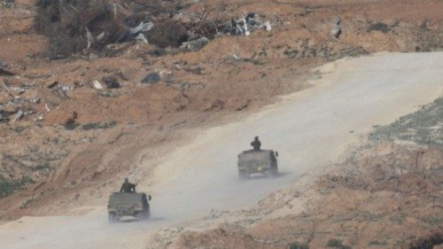 epa11067145 Israeli troops patrol near Buraij refugee camp in the central Gaza Strip, as seen from ...