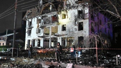 TOPSHOT - Rescuers cordon off the area surrounding a destroyed hotel following a missile strike in ...