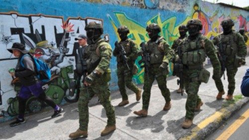 TOPSHOT - Members of the Army's Elite Forces patrol the streets of Carapungo, a popular ... TOPSHOT - Members of the Army's Elite Forces patrol the streets of Carapungo, a popular ...