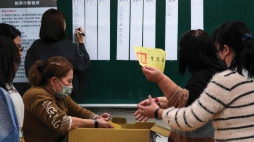 An official of a polling station holds a ballot, as vote counting for the presidential election ... An official of a polling station holds a ballot, as vote counting for the presidential election ...