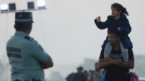 A girl waves while migrants walk in a caravan as an attempt to reach the U.S. border, in Oaxaca ... A girl waves while migrants walk in a caravan as an attempt to reach the U.S. border, in Oaxaca ...