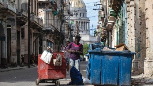 epa11076696 A woman searches through a garbage container a block away from the National Capitol ... epa11076696 A woman searches through a garbage container a block away from the National Capitol ...