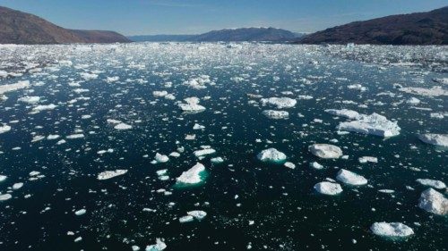 (FILES) This photograph taken on August 15, 2023, shows water melting from an iceberg in Scoresby ...