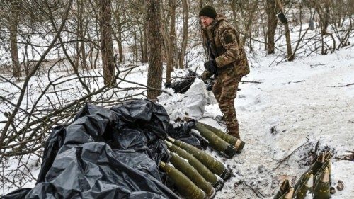 A Ukrainian serviceman stands next to 155-mm artillery shells at a position near a front line, amid ... A Ukrainian serviceman stands next to 155-mm artillery shells at a position near a front line, amid ...