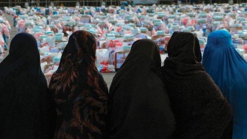 Afghan women wait to receive aid packages which includes food, clothes, and sanitary materials, ... Afghan women wait to receive aid packages which includes food, clothes, and sanitary materials, ...