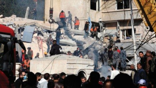 Security and emergency personnel search the rubble of a building destroyed in a reported Israeli ... Security and emergency personnel search the rubble of a building destroyed in a reported Israeli ...