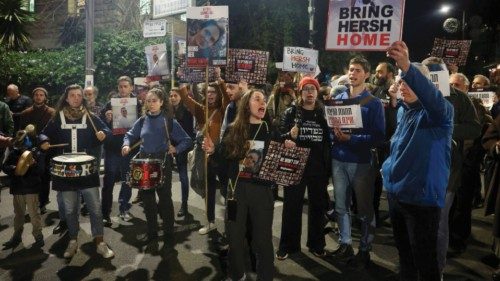 FILE PHOTO: Families of hostages and supporters hold banners during a protest to call for the ...