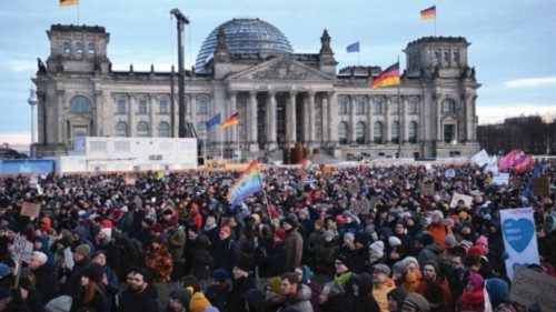 People gather in front of the Reichstag building, seat of the lower house of parliament Bundestag, ... People gather in front of the Reichstag building, seat of the lower house of parliament Bundestag, ...