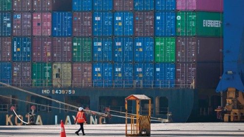 This picture taken on January 11, 2024, a worker walks near a cargo ship docked at Mundra Port, ... This picture taken on January 11, 2024, a worker walks near a cargo ship docked at Mundra Port, ...
