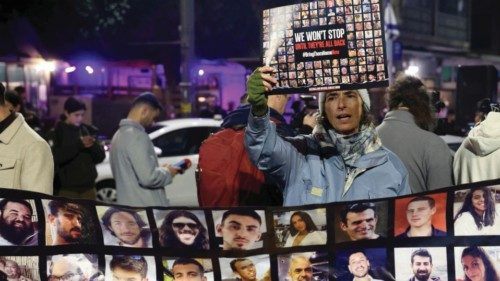 FILE PHOTO: A person holds a placard, as families of hostages and supporters protest to call for the ... FILE PHOTO: A person holds a placard, as families of hostages and supporters protest to call for the ...