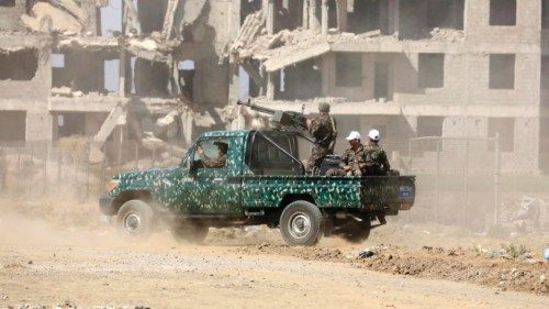 epa11104217 Houthi troopers aboard a pick-up truck driving past a previous bombing-destroyed ... epa11104217 Houthi troopers aboard a pick-up truck driving past a previous bombing-destroyed ...