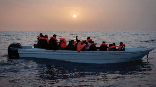 TOPSHOT - Migrants from Syria and Bangladesh are assisted on January 18, 2024 by a rescue team from ...