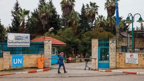 A Palestinian woman walks in front of the entrance of the UNRWA-run University College for ...