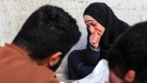 EDITORS NOTE: Graphic content / Palestinians mourn over the body of a loved one, at the Ahli Arabi ... EDITORS NOTE: Graphic content / Palestinians mourn over the body of a loved one, at the Ahli Arabi ...