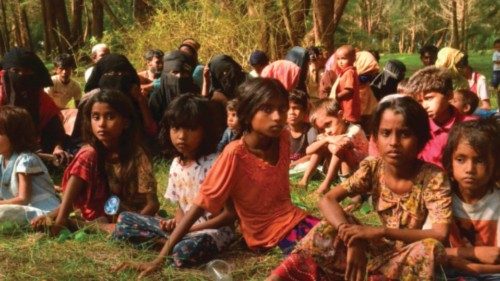 Newly arrived Rohingya refugees rest after landing on the beach in Kuala Parek in East Aceh on ... Newly arrived Rohingya refugees rest after landing on the beach in Kuala Parek in East Aceh on ...