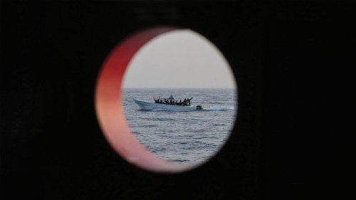 Migrants sailing in international waters aboard a small wooden boat are seen from the Spanish NGO ... Migrants sailing in international waters aboard a small wooden boat are seen from the Spanish NGO ...