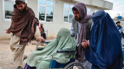 A differently abled Afghan burqa-clad woman (C) is carried on a wheelchair distributed by Ummah ... A differently abled Afghan burqa-clad woman (C) is carried on a wheelchair distributed by Ummah ...
