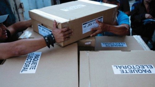 Employees of the Supreme Electoral Tribunal (TSE) load boxes containing electoral material for the ...