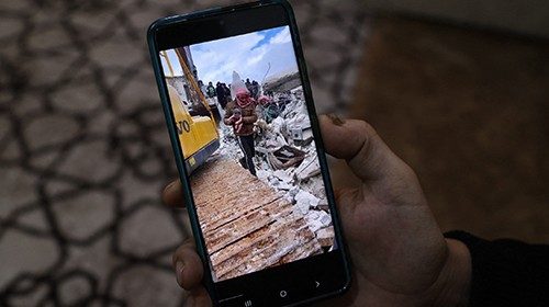 Khalil al-Sawadi shows a picture of himself carrying his newborn niece Aafraa after saving her from ...