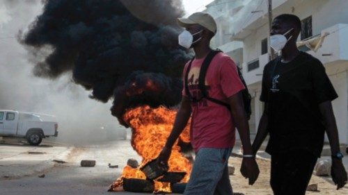 TOPSHOT - Opposition supporters walk next to a burning barricade during demonstrations called by the ... TOPSHOT - Opposition supporters walk next to a burning barricade during demonstrations called by the ...