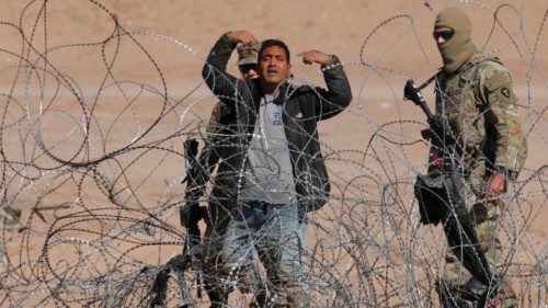 TOPSHOT - A migrant man with blood in his face gestures after having crossed a fence of spikes ...