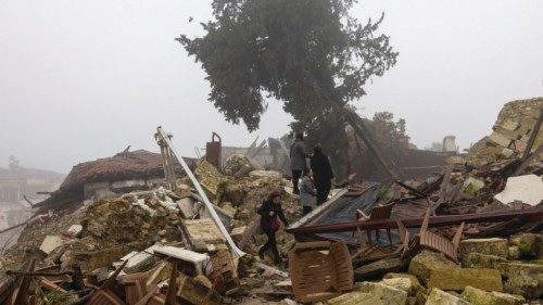 Worshippers walk on the ruins before they attend a mass for those of their community killed by last ... Worshippers walk on the ruins before they attend a mass for those of their community killed by last ...