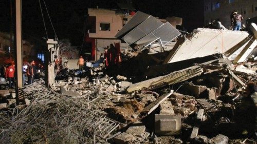Rescuers search for survivors under the rubble of a damaged building, after Israeli missiles struck ... Rescuers search for survivors under the rubble of a damaged building, after Israeli missiles struck ...