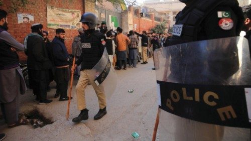 epa11136344 Pakistani security officials stand guard outside a polling station during general ... epa11136344 Pakistani security officials stand guard outside a polling station during general ...