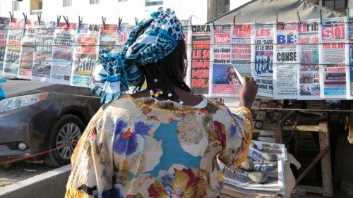 A Senegalese woman reads the headlines of the newspapers on sale in a street in Dakar on February ...