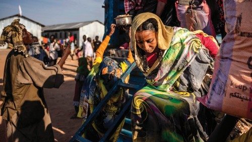 A Sudanese woman who has fled from the war in Sudan gets off a truck loaded with Sudanese families ...